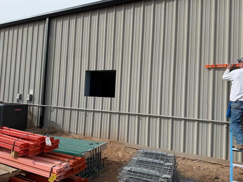 Window openings being cut and framed mid-installation