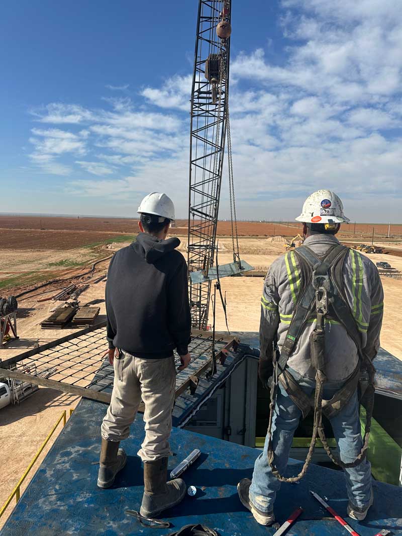 Glass being installed on oilfield rig structure